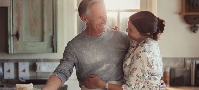 Happy couple cooking in their kitchen