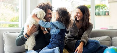 Happy family with their dog on a couch