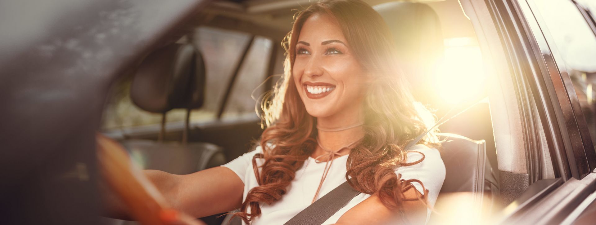 Young adult driving a new car