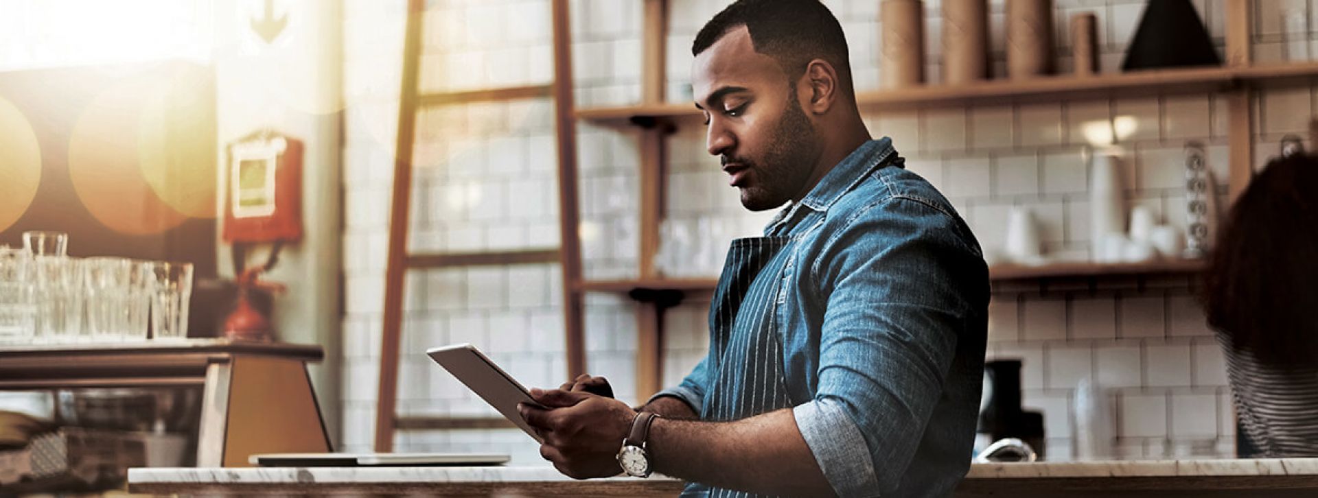 Man using his tablet in coffee shop