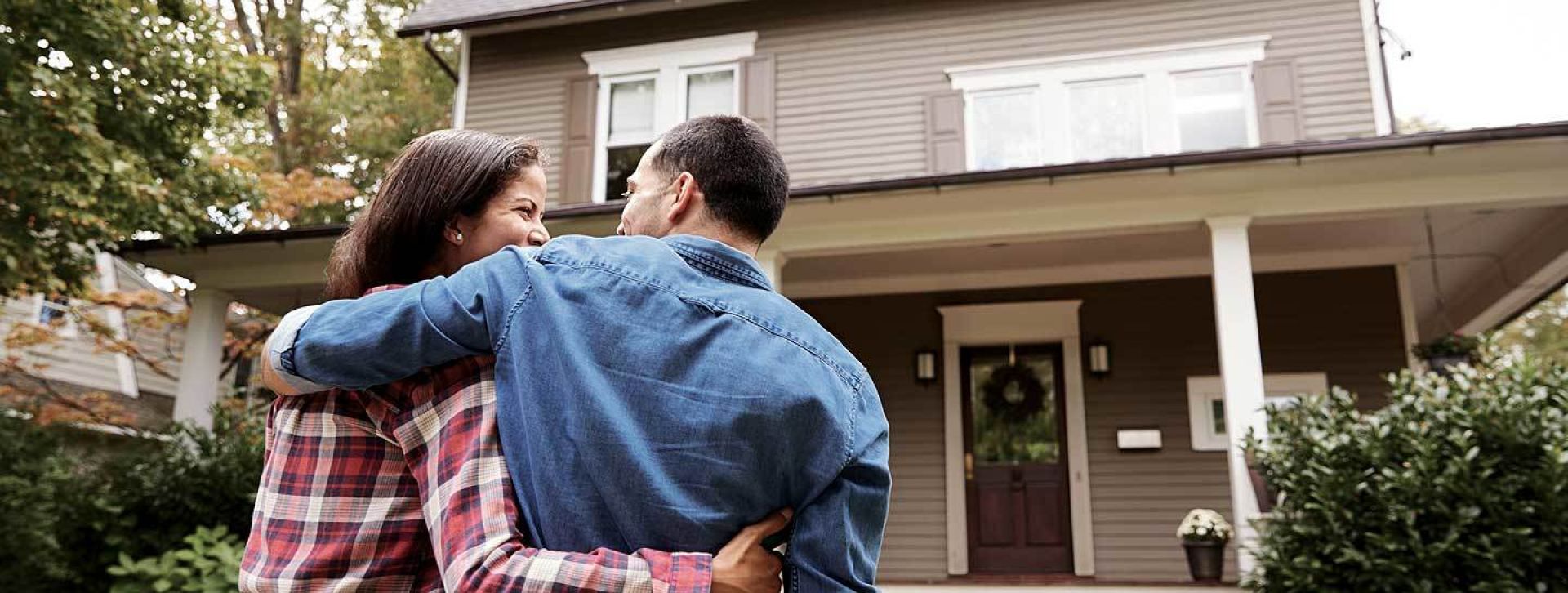 Happy couple moving into their new home