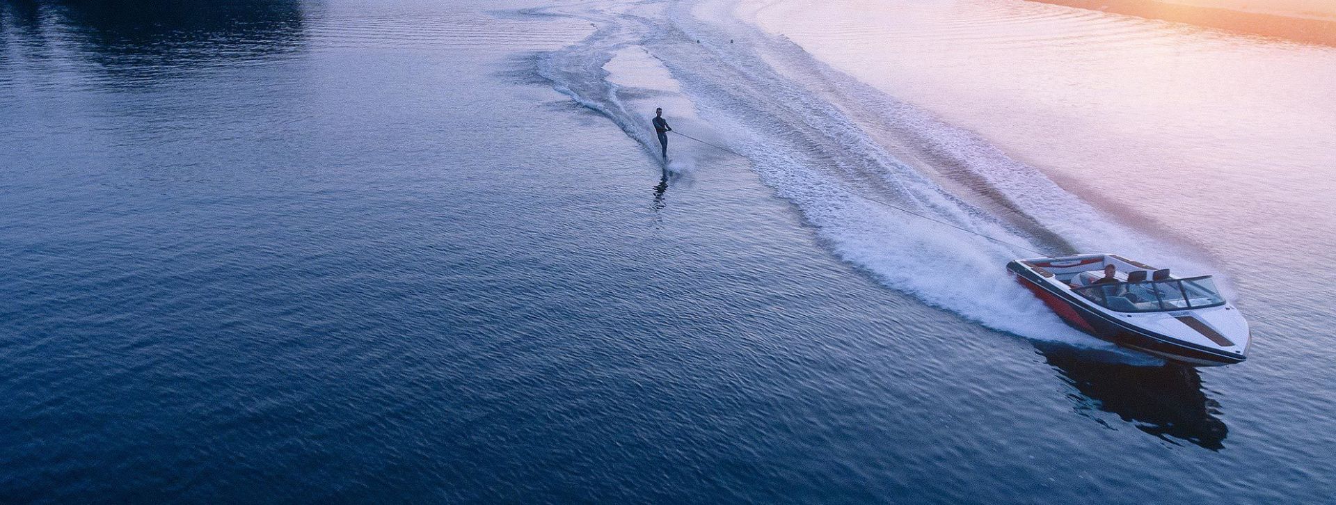 Boat with water skier on lake