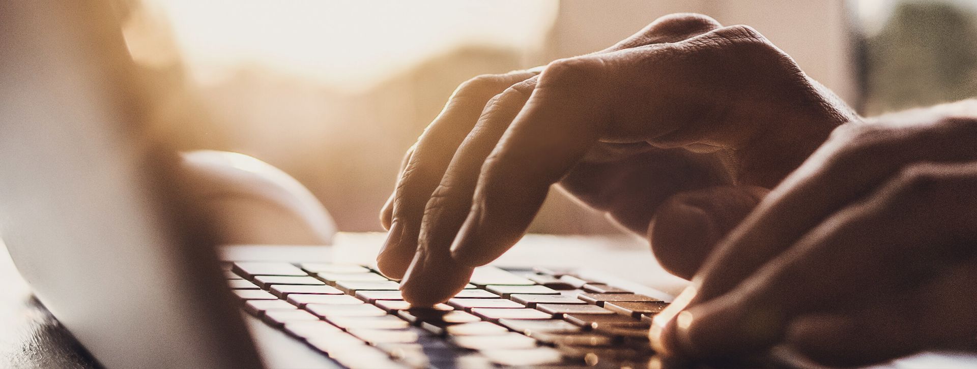 Hands typing on a keyboard