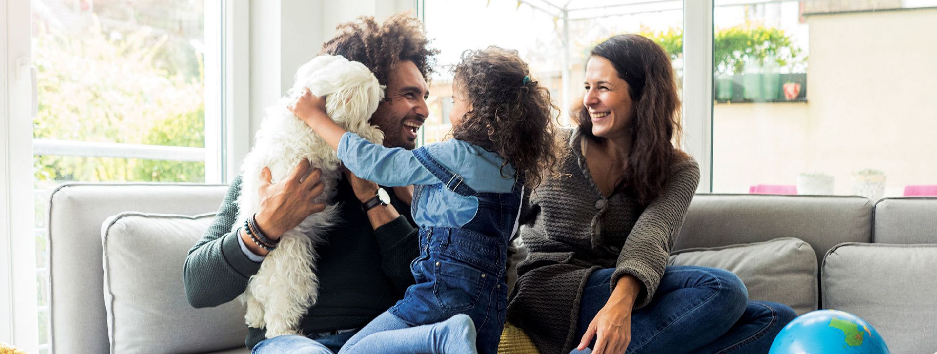 Happy family with their dog on a couch